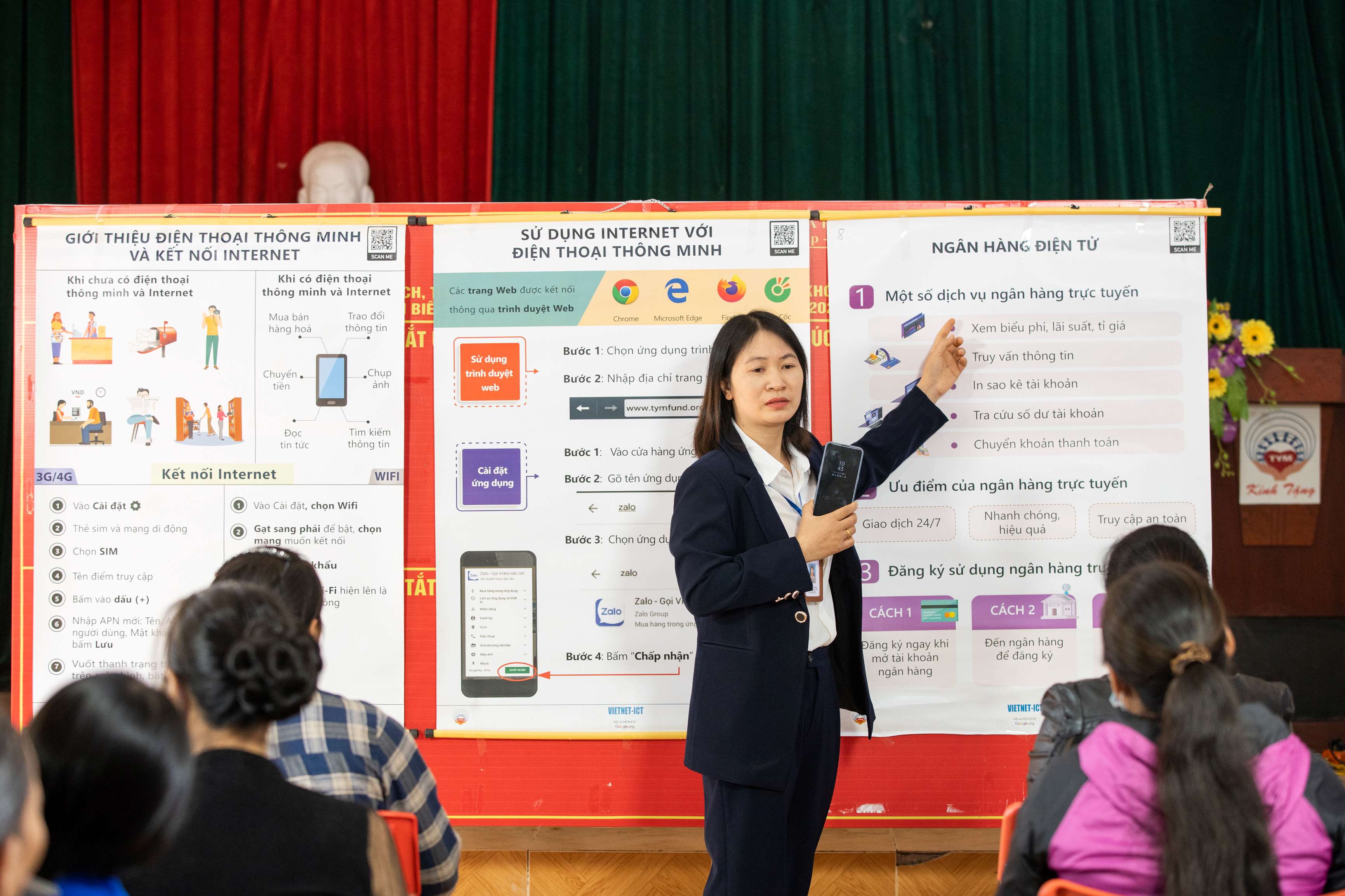 Cán bộ TYM - Hội LHPN Việt Nam hướng dẫn hội viên sử dụng dịch vụ ngân hàng điện tử trên thiết bị di động